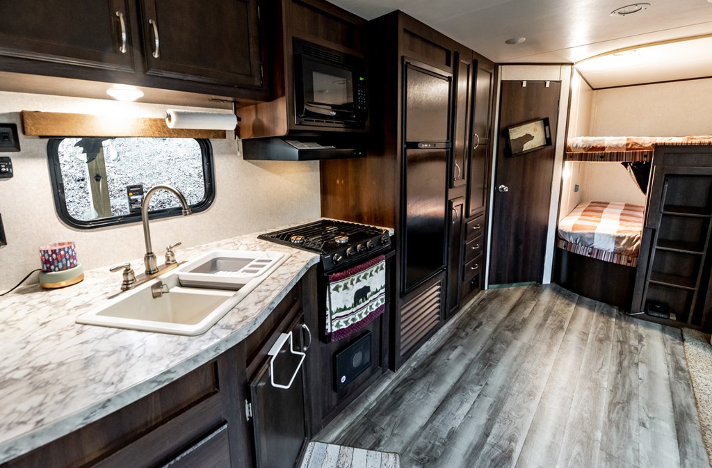 107 23rd Street Ellijay, GA 30540 - Photo 11 of 45 a kitchen with stainless steel appliances granite countertop a refrigerator a stove and a sink with wooden floor