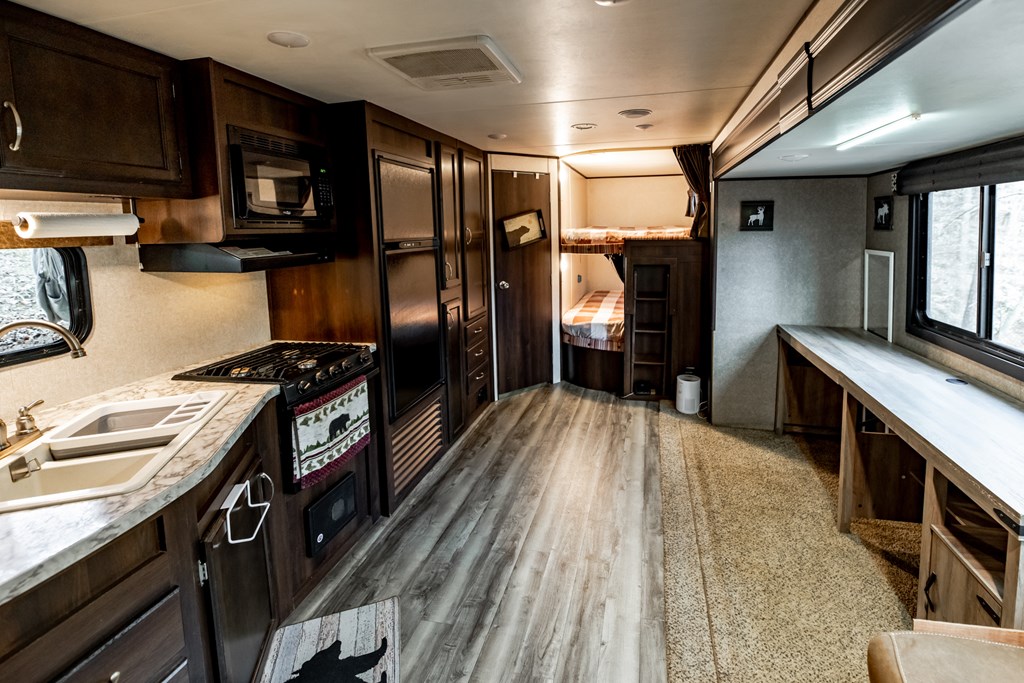 107 23rd Street Ellijay, GA 30540 - Photo 12 of 45 a kitchen with granite countertop a refrigerator stove and sink