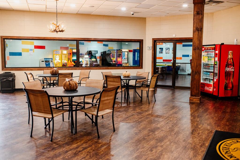 107 23rd Street Ellijay, GA 30540 - Photo 20 of 45 a dining room with wooden floor a glass table and chairs