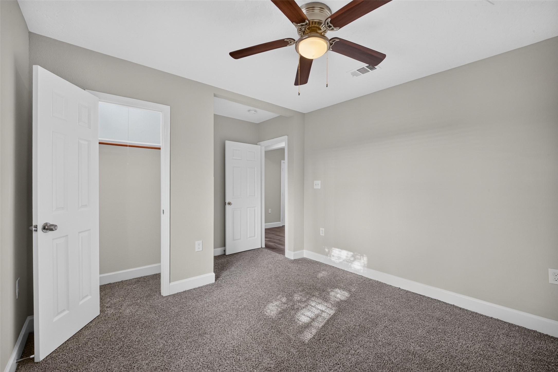 5217 Pomander Road Houston, TX 77021 - Photo 16 of 18 Spacious bedroom featuring soft neutral tones, plush carpeting, a ceiling fan, and generous closet space.