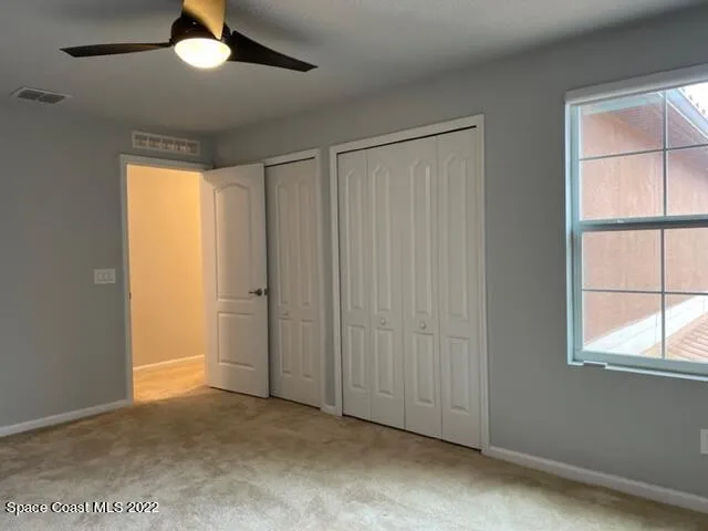 an empty room with windows and closet