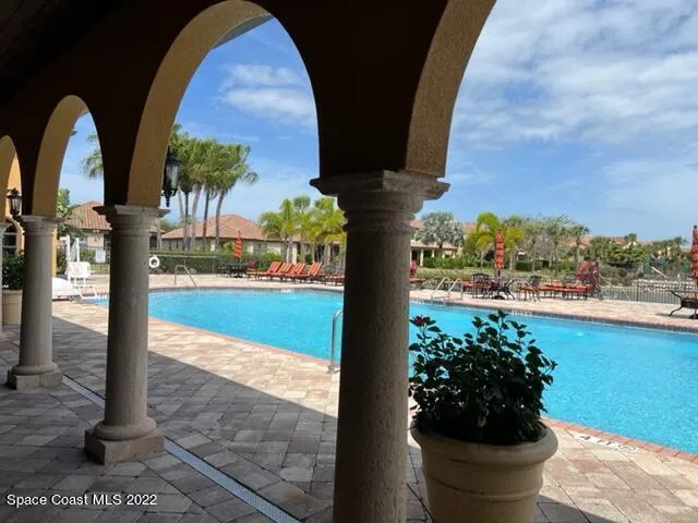 a living room with furniture a large window and a fireplace