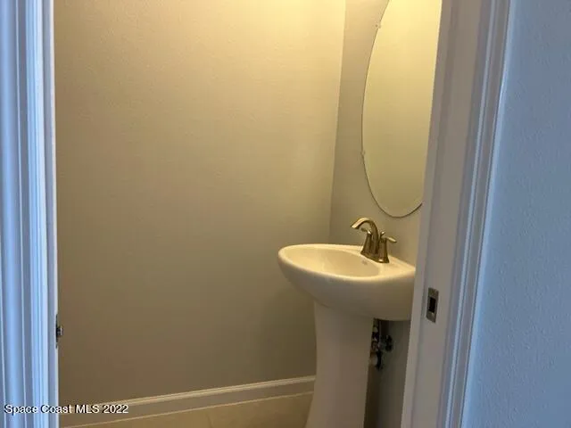 a bathroom with a sink and mirror