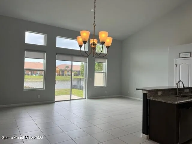 a view of a room with a chandelier furniture and windows
