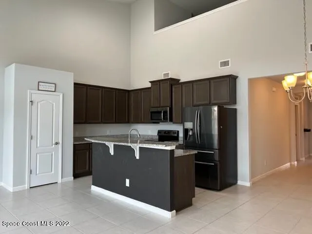 a kitchen with a refrigerator and a sink