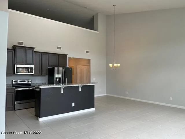 a kitchen with stainless steel appliances a refrigerator stove and microwave