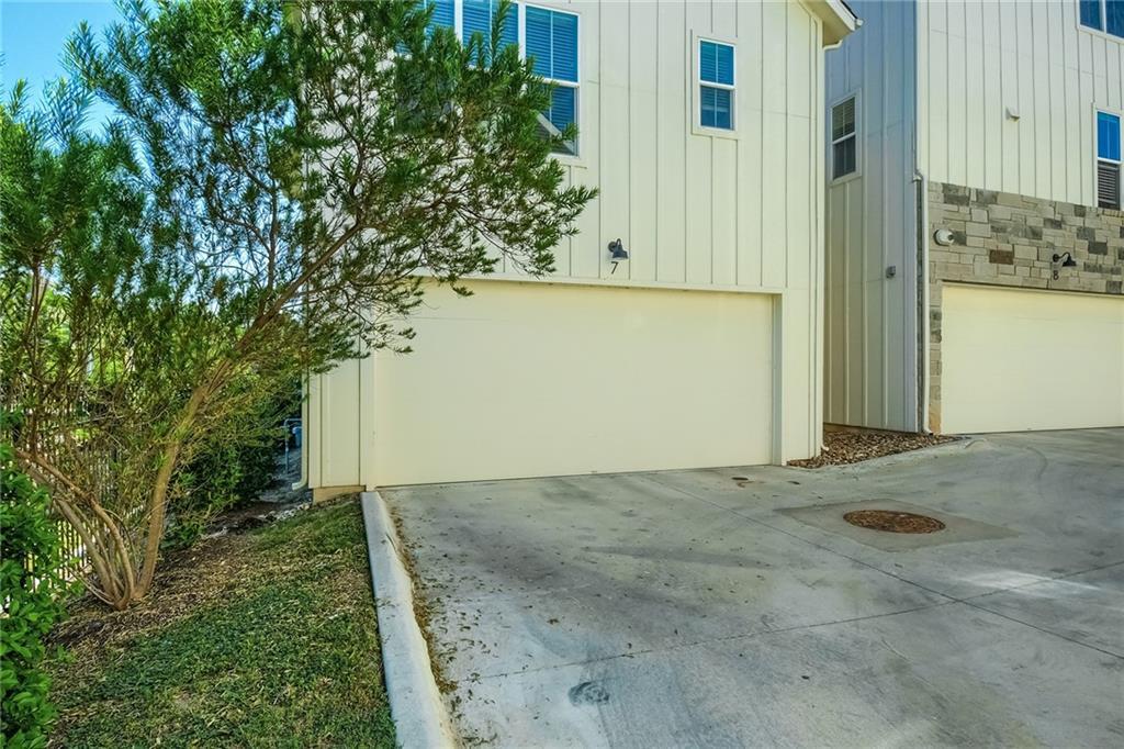 2624 Metcalfe Road, Unit 7 Austin, TX 78741 - Photo 29 of 31 Two-story exterior featuring vertical white siding and stone accents