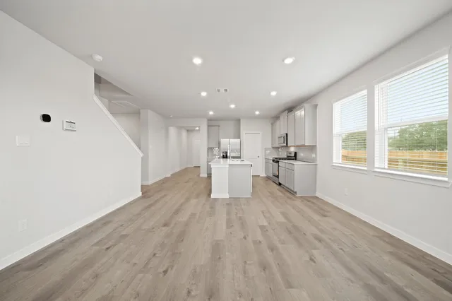 a view of kitchen with wooden floor and windows