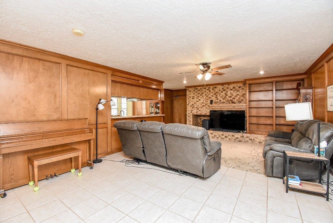 2719 Vail Road Rosenberg, TX 77471 - Photo 16 of 37 a living room with furniture a fireplace and a flat screen tv