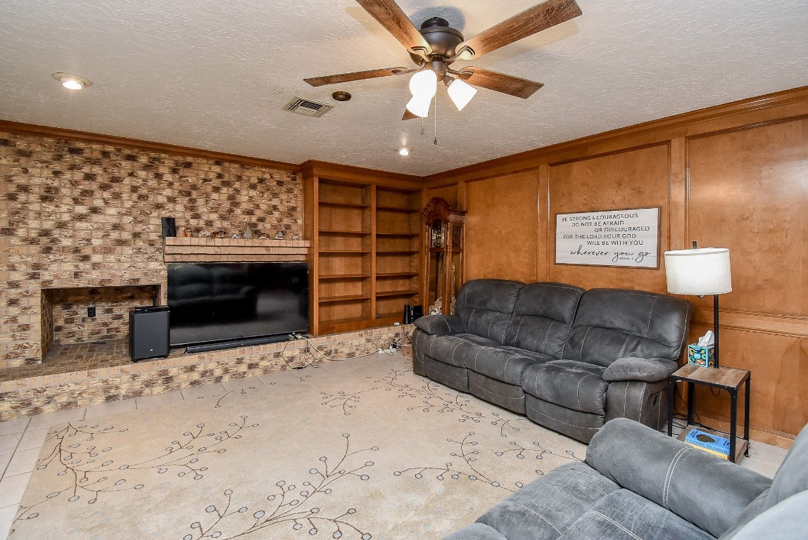 2719 Vail Road Rosenberg, TX 77471 - Photo 17 of 37 a living room with furniture a fireplace and a ceiling fan