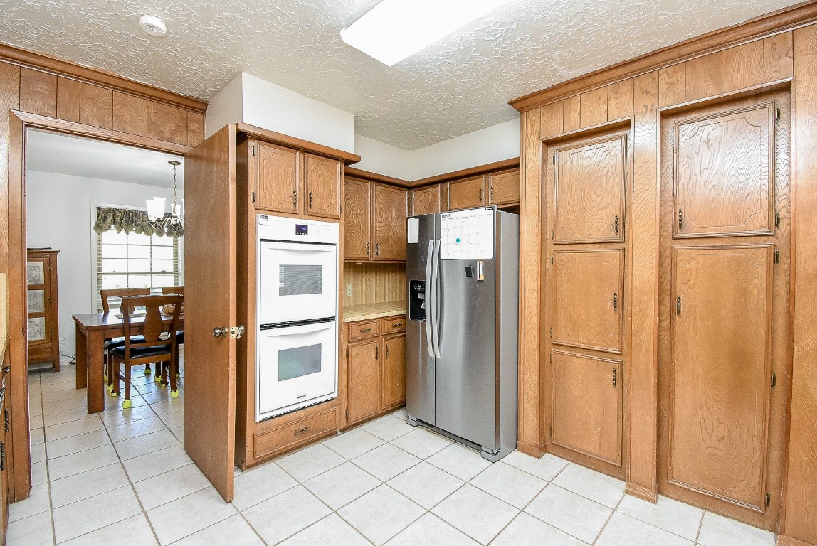 2719 Vail Road Rosenberg, TX 77471 - Photo 22 of 37 a kitchen with stainless steel appliances a refrigerator and microwave