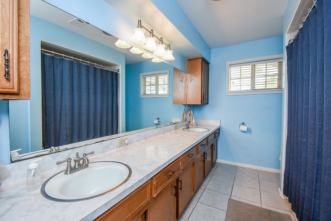2719 Vail Road Rosenberg, TX 77471 - Photo 27 of 37 a bathroom with a granite countertop sink and a mirror