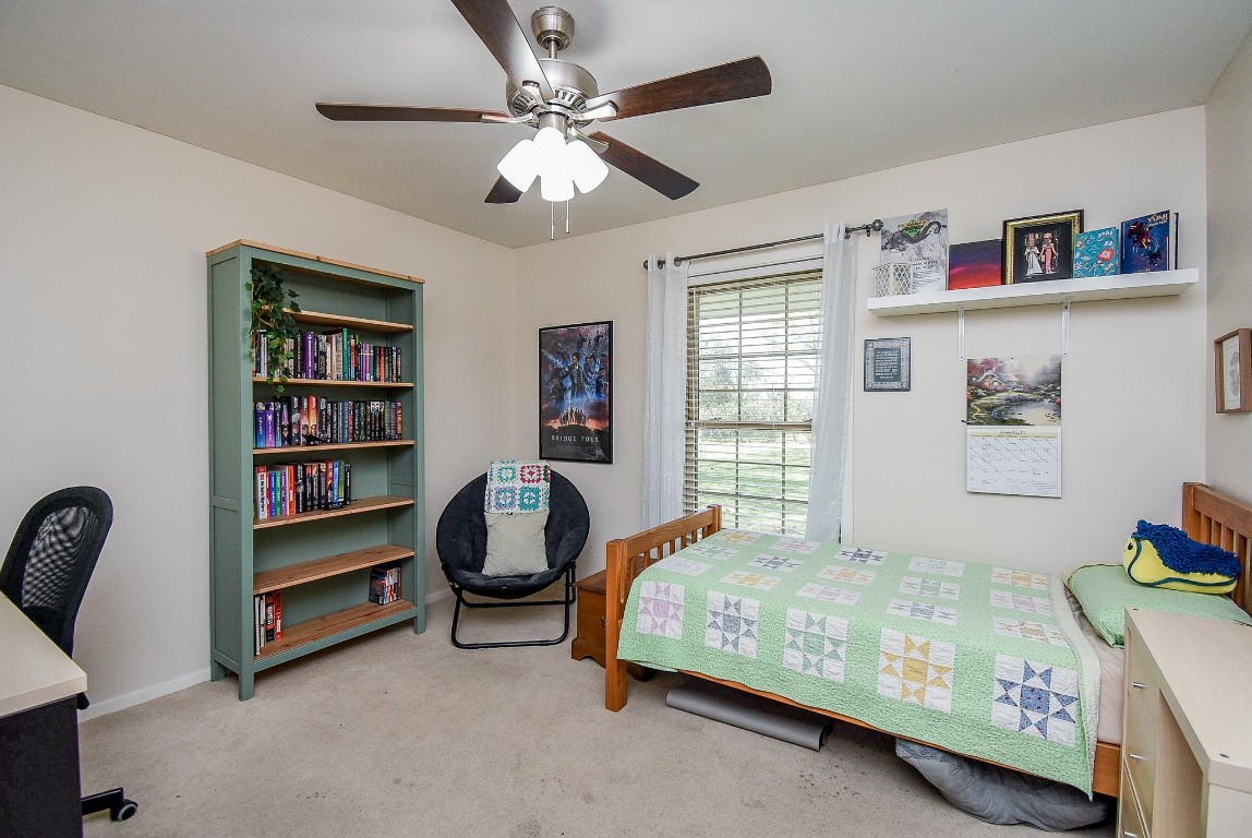 2719 Vail Road Rosenberg, TX 77471 - Photo 30 of 37 a bedroom with bed and a chandelier