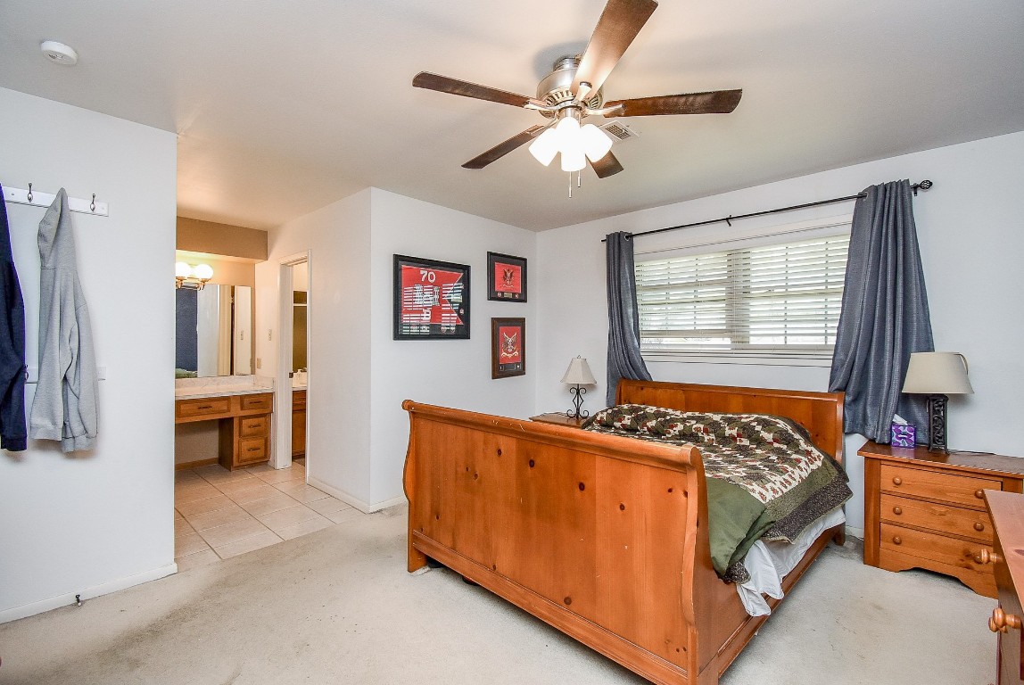 2719 Vail Road Rosenberg, TX 77471 - Photo 33 of 37 a bed room with a bed and a chandelier