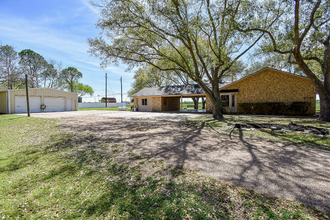 2719 Vail Road Rosenberg, TX 77471 - Photo 9 of 37 a view of a yard with a house and a large tree