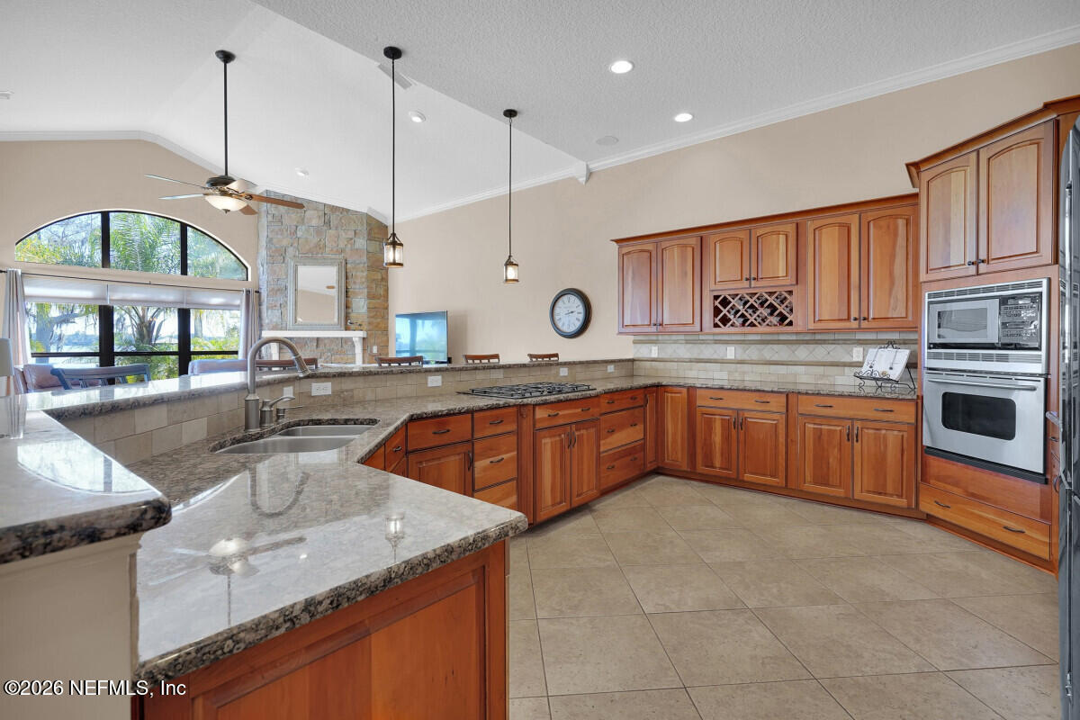 2942 Magnolia Road Orange Park, FL 32065 - Photo 12 of 50 a kitchen with stainless steel appliances granite countertop a sink a stove and a wooden floors