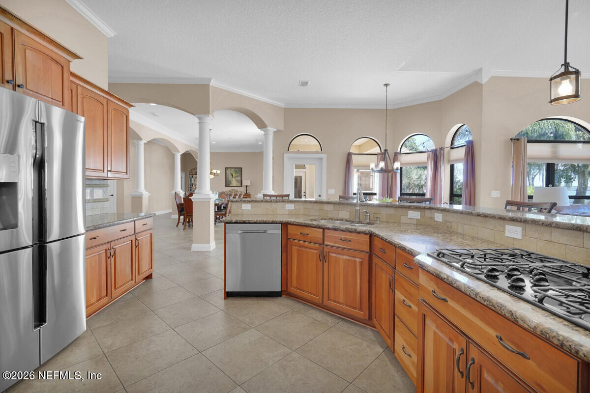 2942 Magnolia Road Orange Park, FL 32065 - Photo 13 of 50 a large kitchen with granite countertop a sink and a refrigerator