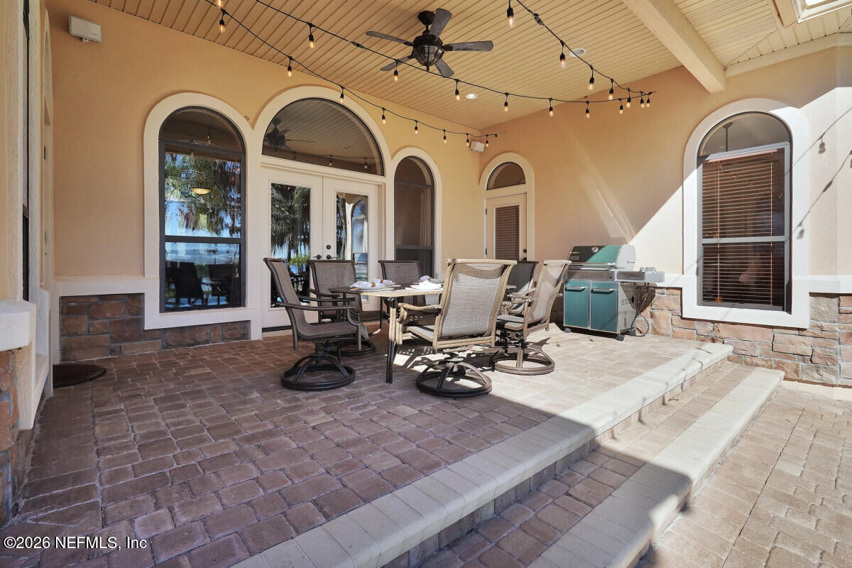 2942 Magnolia Road Orange Park, FL 32065 - Photo 16 of 50 a living room with furniture a fireplace and large windows