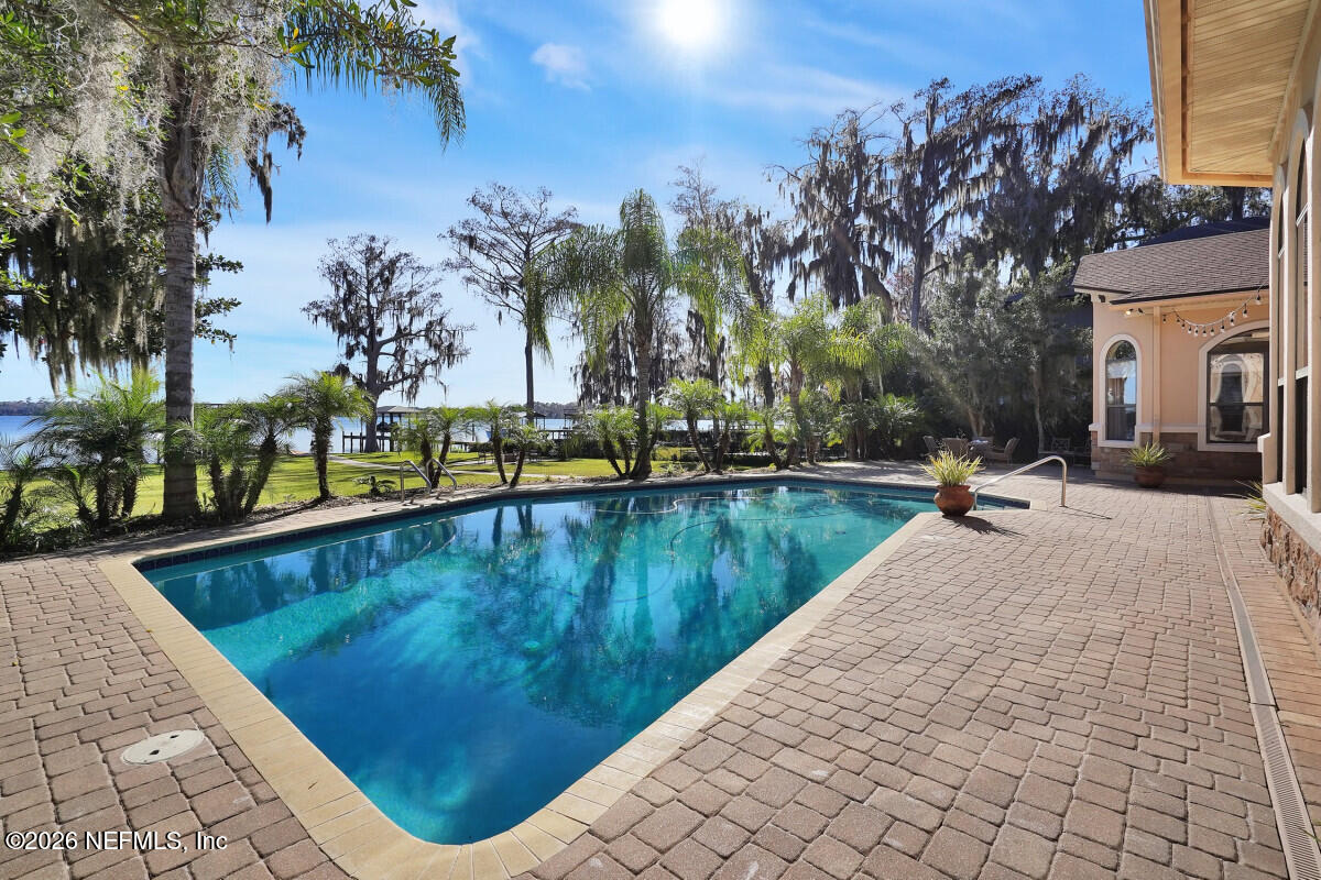 2942 Magnolia Road Orange Park, FL 32065 - Photo 18 of 50 a view of swimming pool with outdoor seating and lake view