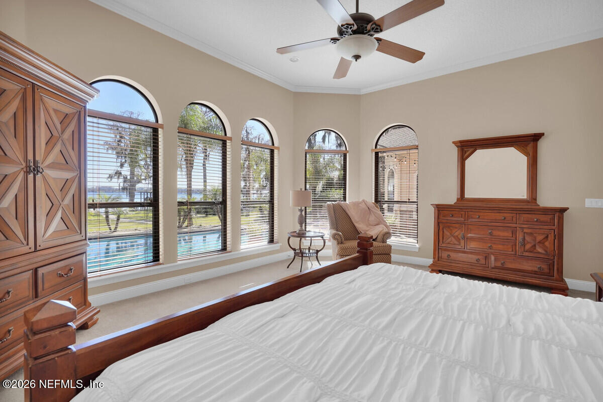 2942 Magnolia Road Orange Park, FL 32065 - Photo 21 of 50 a bedroom with a large bed and wooden floor