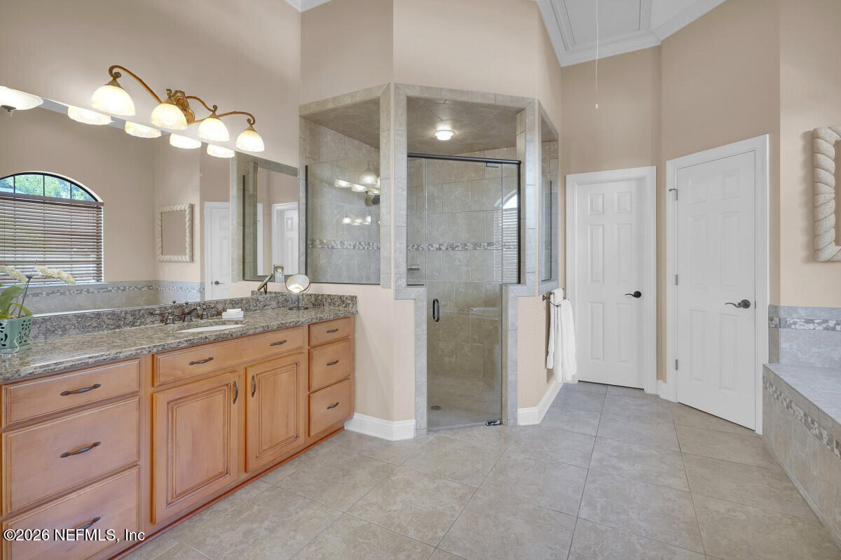 2942 Magnolia Road Orange Park, FL 32065 - Photo 24 of 50 a bathroom with a granite countertop sink a large mirror and a shower