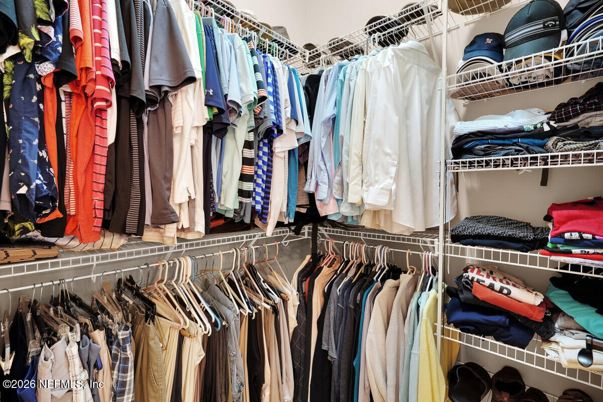 2942 Magnolia Road Orange Park, FL 32065 - Photo 27 of 50 a view of walk in closet with clothes and shoes