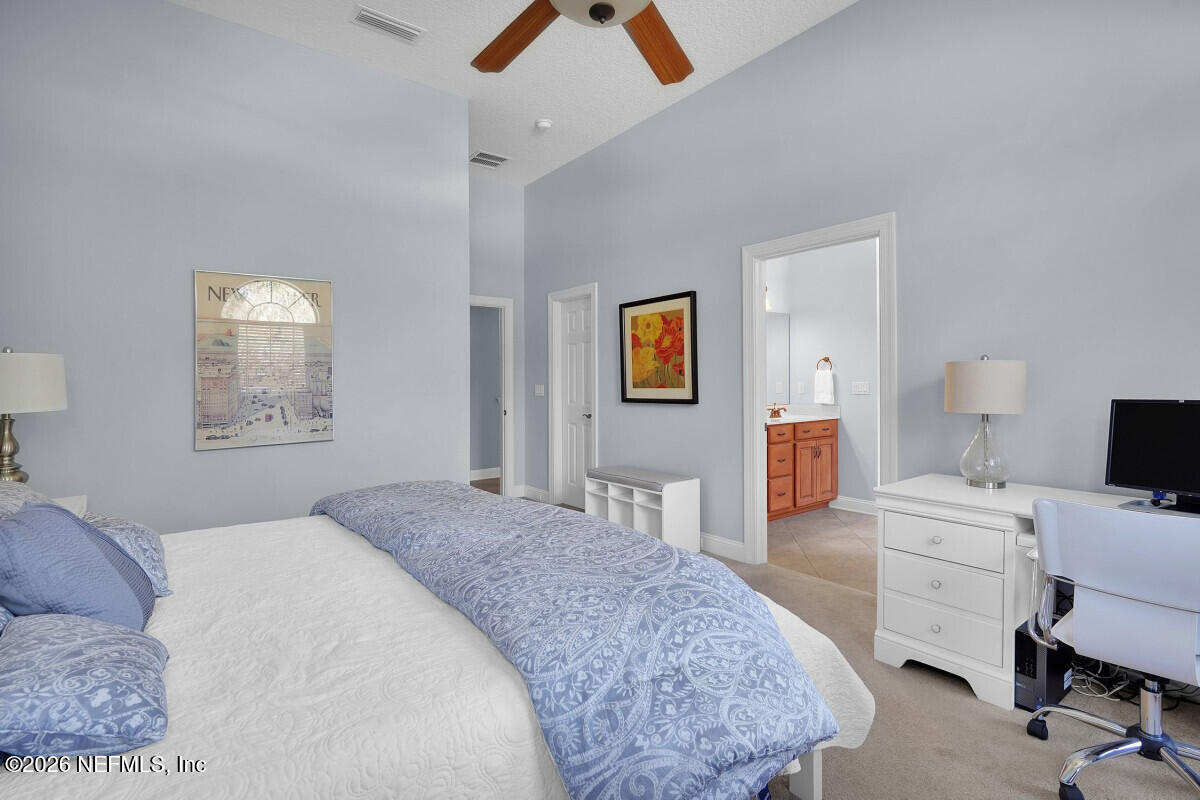 2942 Magnolia Road Orange Park, FL 32065 - Photo 29 of 50 a bedroom with a bed and a chandelier