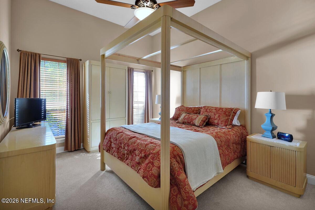 2942 Magnolia Road Orange Park, FL 32065 - Photo 32 of 50 a bedroom with a bed and a flat tv screen on dresser