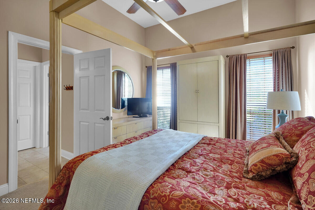 2942 Magnolia Road Orange Park, FL 32065 - Photo 33 of 50 a bedroom with a bed and a large mirror with a flat tv screen