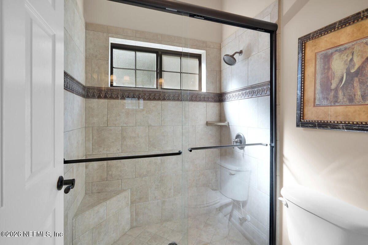 2942 Magnolia Road Orange Park, FL 32065 - Photo 35 of 50 a bathroom with a glass shower door