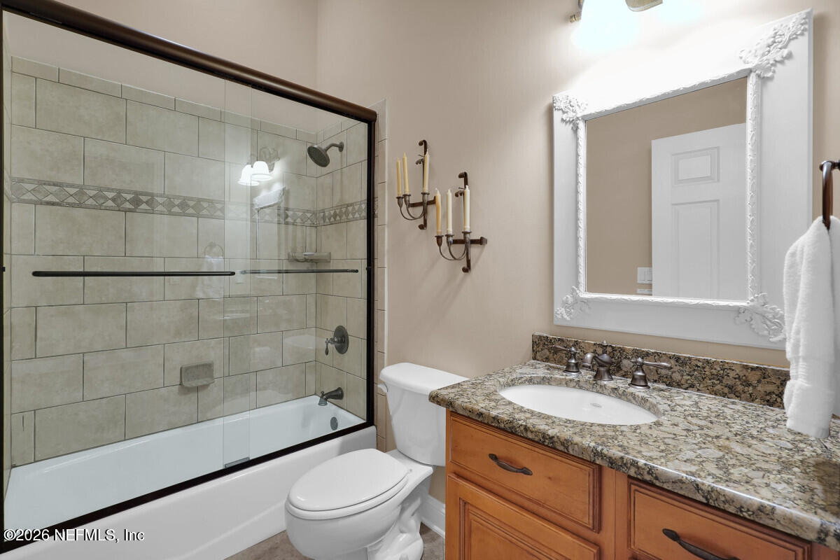 2942 Magnolia Road Orange Park, FL 32065 - Photo 37 of 50 a bathroom with a granite countertop sink toilet and shower