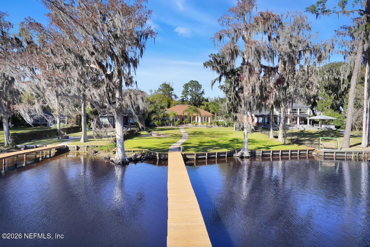 2942 Magnolia Road Orange Park, FL 32065 - Photo 42 of 50 a swimming pool with outdoor seating and yard