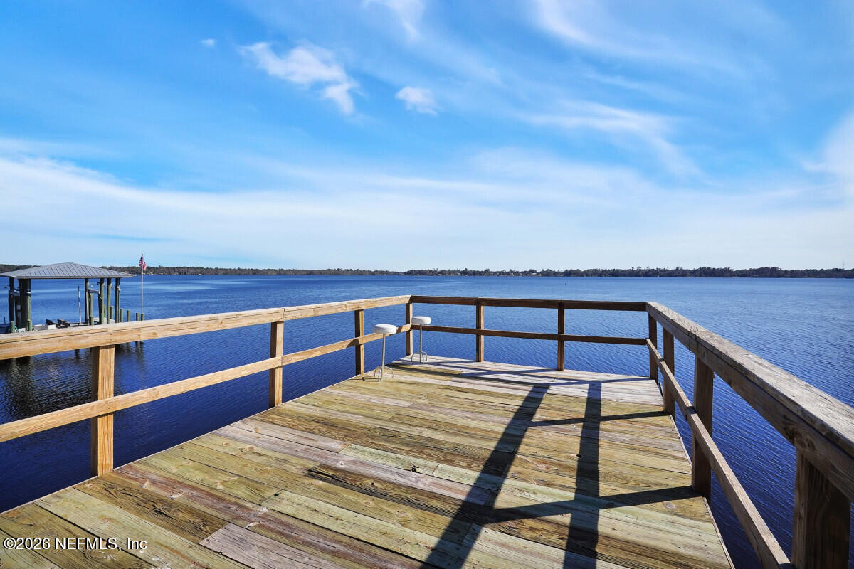 2942 Magnolia Road Orange Park, FL 32065 - Photo 43 of 50 a view of a balcony with wooden floor and iron stairs