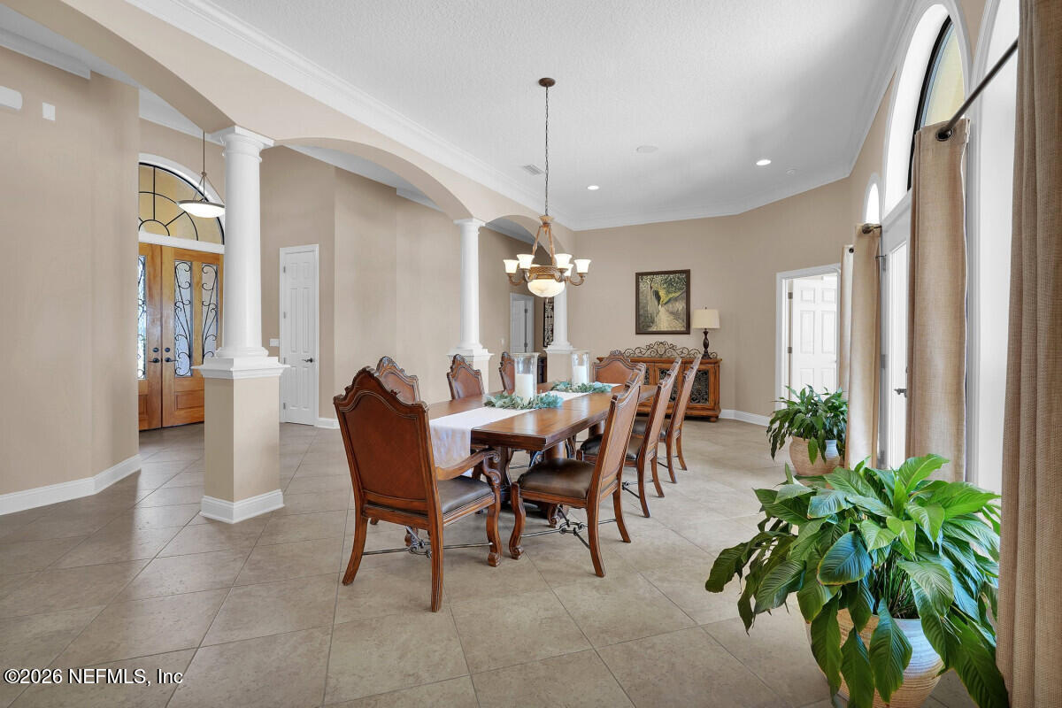2942 Magnolia Road Orange Park, FL 32065 - Photo 10 of 50 a dining room with furniture potted plants and wooden floor