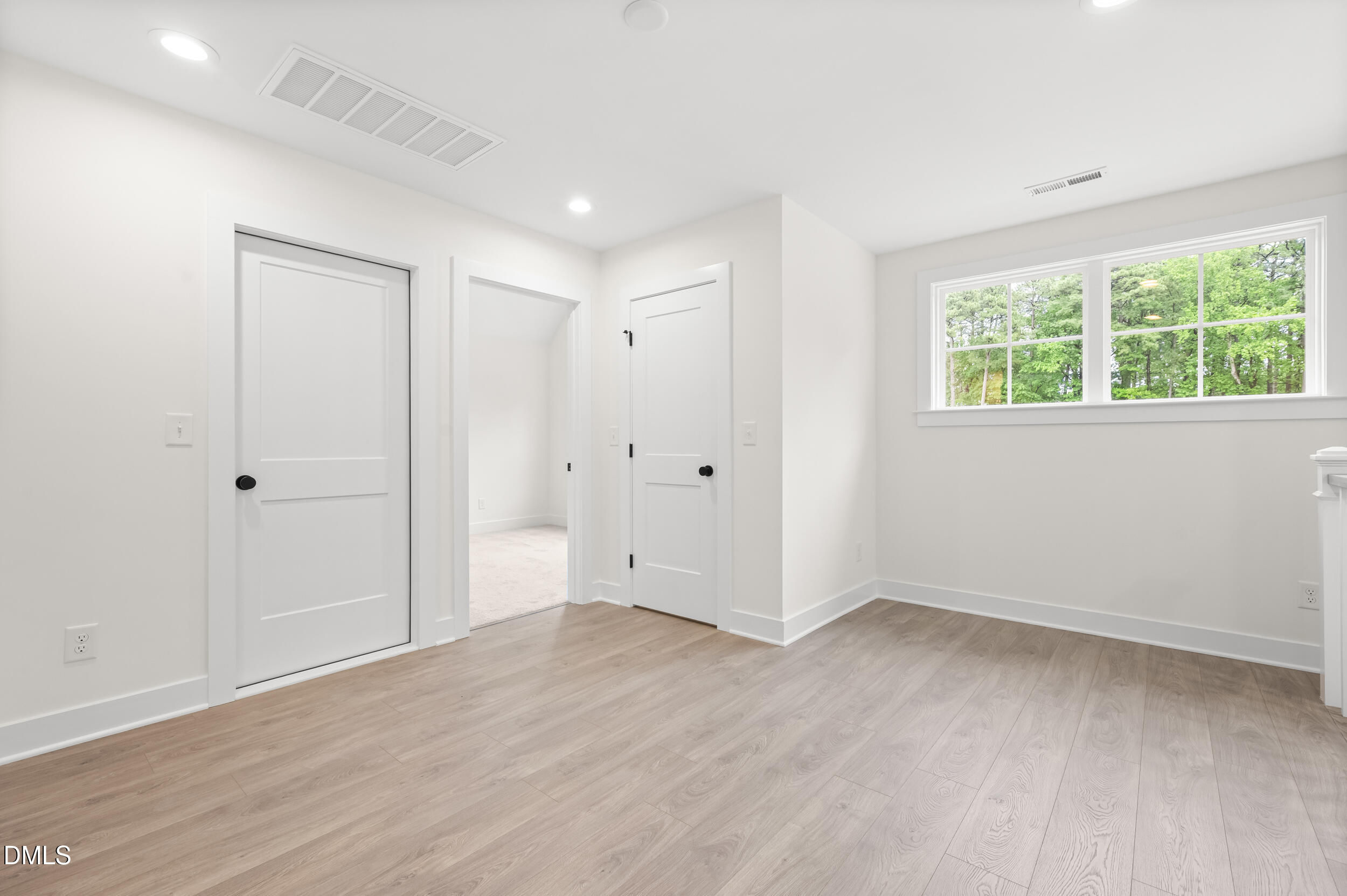 708 Grayhaven Place Raleigh, NC 27606 - Photo 21 of 33 a view of an empty room with wooden floor and a window