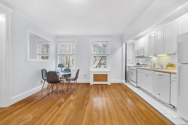 a kitchen with wooden floors and wooden cabinets
