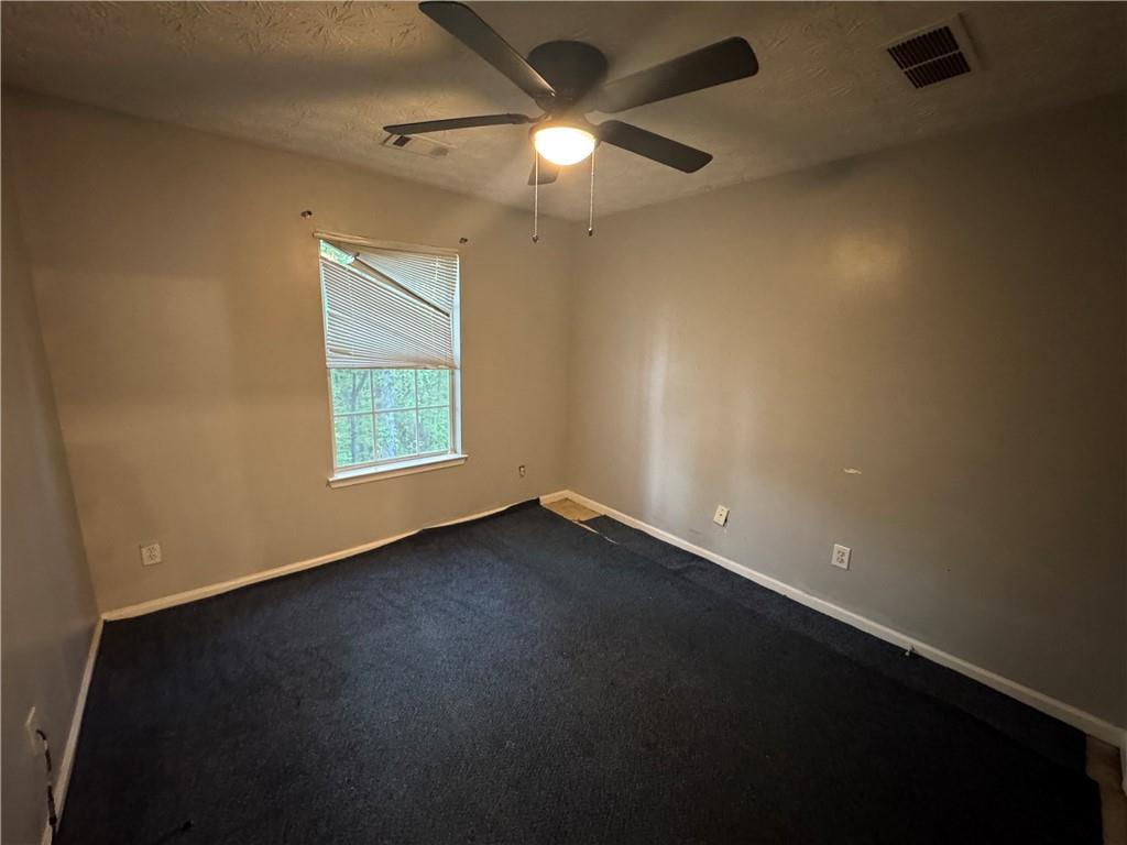 3653 Woodland Cove Decatur, GA 30034 - Photo 12 of 19 an empty room with a window and a ceiling fan