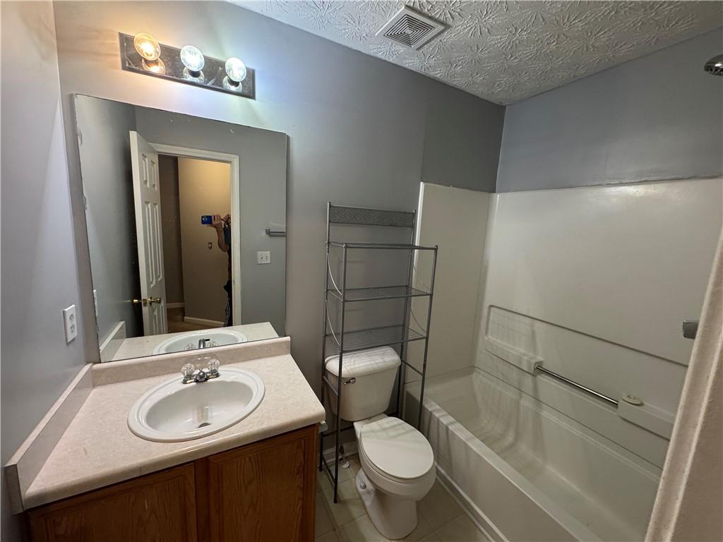 3653 Woodland Cove Decatur, GA 30034 - Photo 16 of 19 a bathroom with a sink toilet and mirror