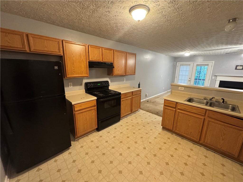 3653 Woodland Cove Decatur, GA 30034 - Photo 2 of 19 a kitchen with a sink a stove and refrigerator