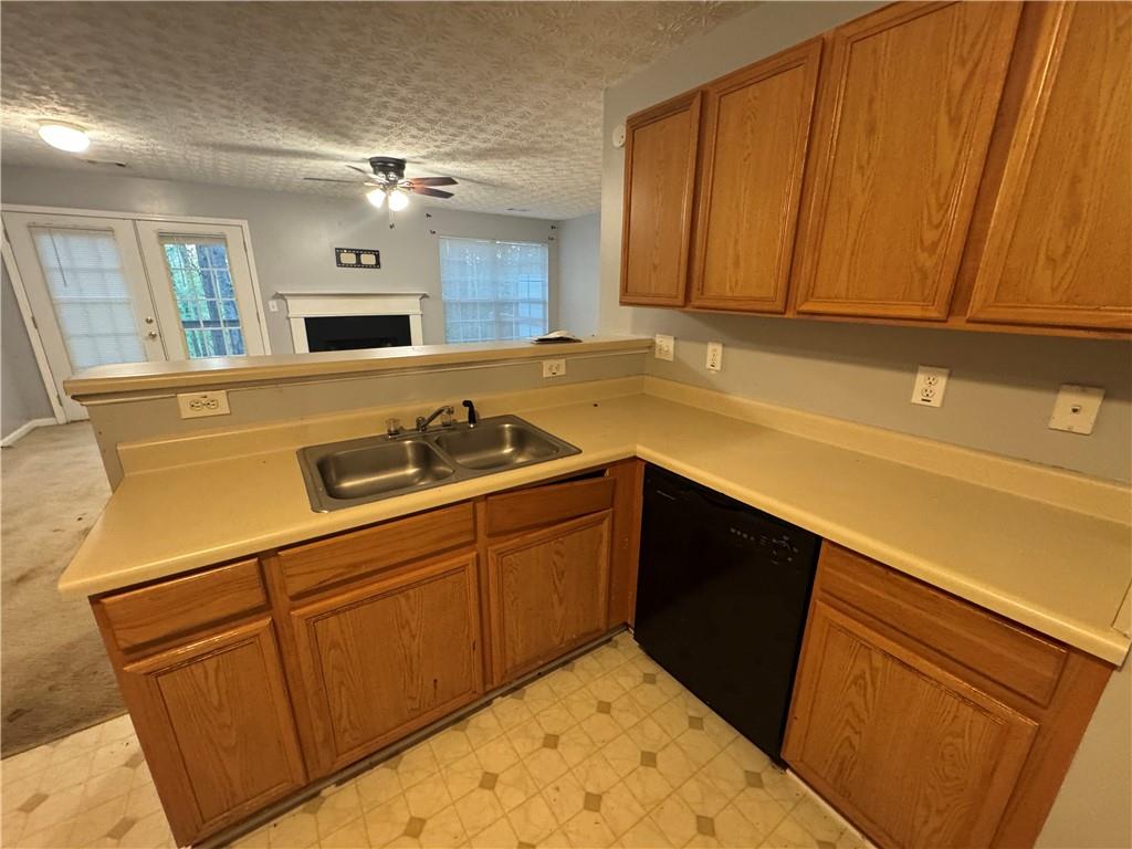 3653 Woodland Cove Decatur, GA 30034 - Photo 3 of 19 a kitchen with granite countertop cabinets sink and white appliances