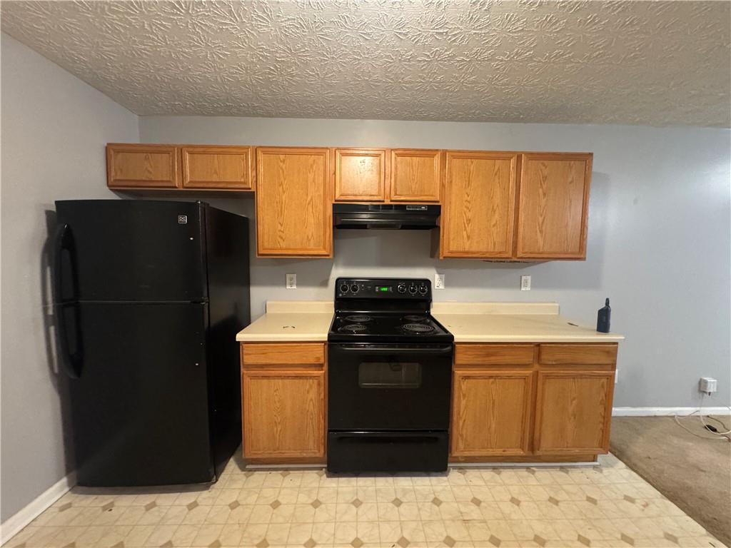3653 Woodland Cove Decatur, GA 30034 - Photo 4 of 19 a kitchen with a sink and a refrigerator