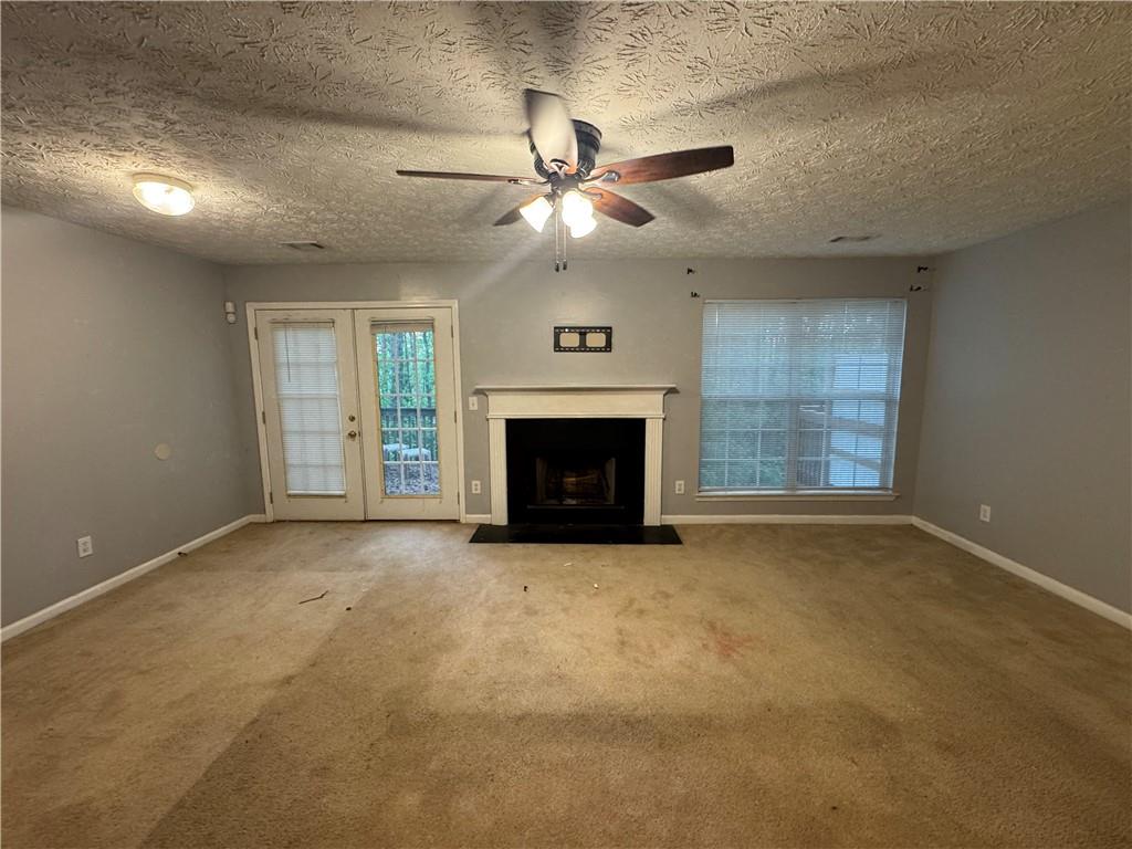 3653 Woodland Cove Decatur, GA 30034 - Photo 8 of 19 an empty room with windows and fireplace