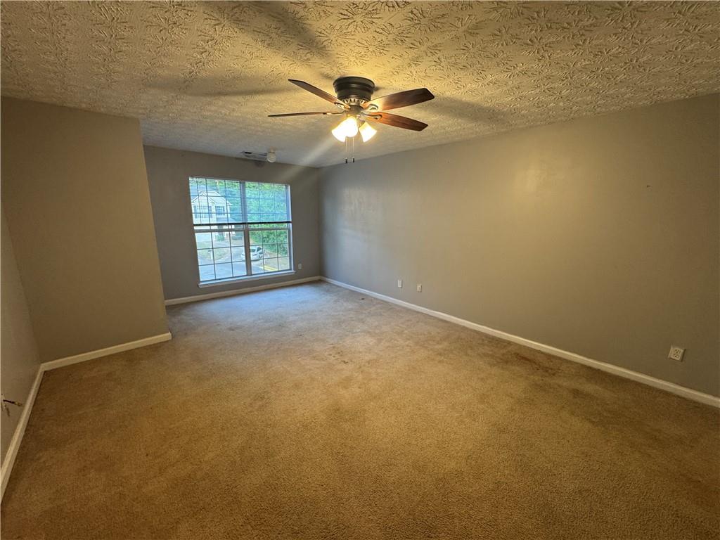 3653 Woodland Cove Decatur, GA 30034 - Photo 10 of 19 an empty room with windows and chandelier fan