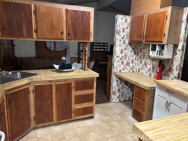 3169 2nd Street, Unit D Clearlake, CA 95422 - Photo 6 of 15 a kitchen with stainless steel appliances wooden cabinets and a sink