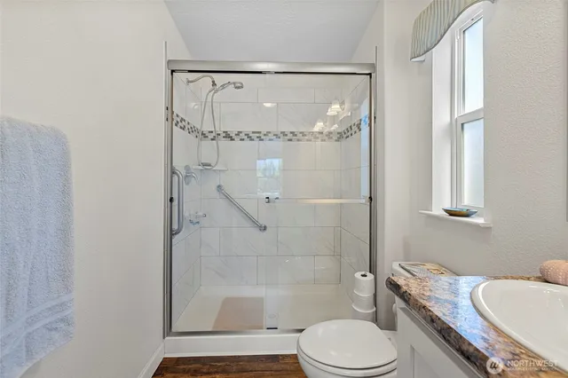 a bathroom with a toilet and shower