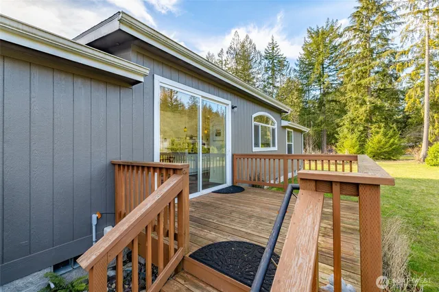 a view of a house with wooden stairs and deck