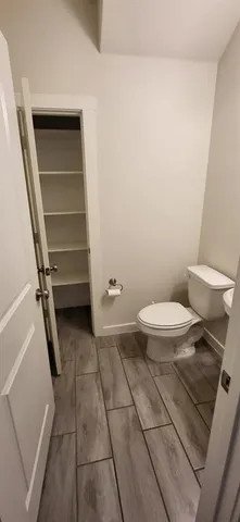 a view of staircase with railing and white walls