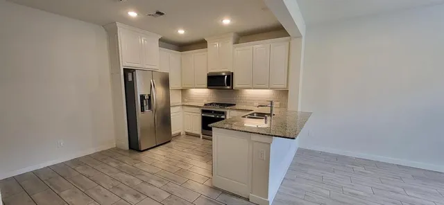 a kitchen that has a sink and a stove in it