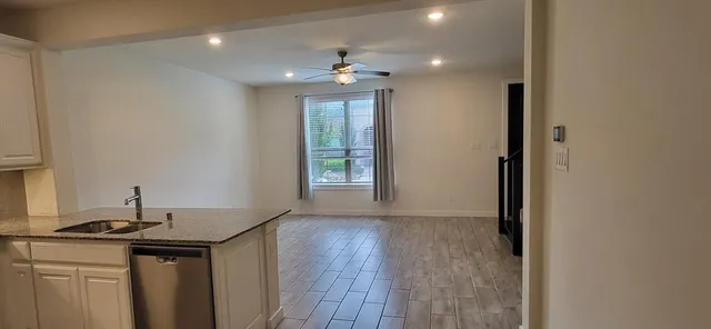 a kitchen with granite countertop a stove and a refrigerator