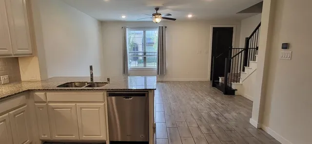 a bathroom with a granite countertop sink a mirror and shower